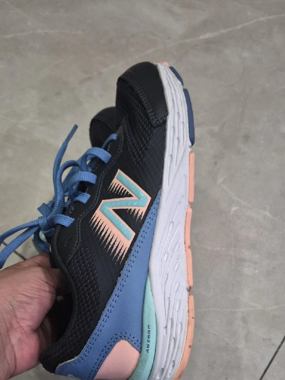 New Balance Women's Black Athletic Sneakers with Blue Laces and Peach Accents